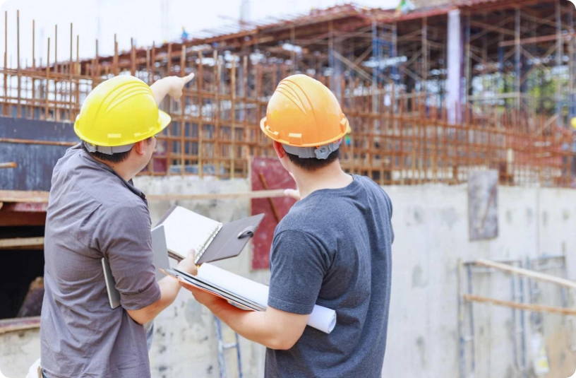 workers going over plans on site