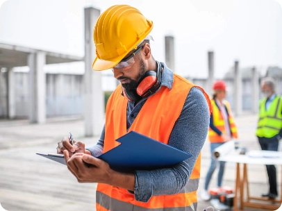 worker going through clipboard on site